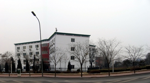 Building viewed from the side, likely a worker's dormitory.