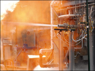 A white-hot flame surrounded by red hot exhaust shoots out from a J-2X engine gas generator.