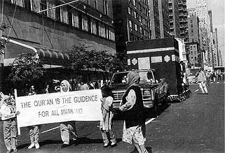 Banners preceding the float of the Ka'aba.