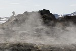 Student walking above steam from geothermal spring.