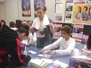 A photo of people at a sign-up table.