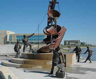 Bronze sculpture of laborers working.