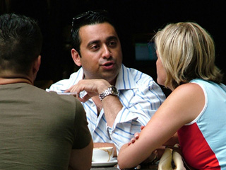 Three friends chat at a coffee shop.