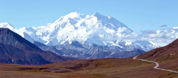 A photo of white capped mountain in the distance.