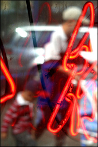 Fugures reflected in a Chinatown shop window, in Boston, MA.