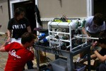 The ROV and tether are loaded onto a wheeled cart.