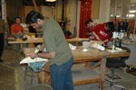 A student in the foreground planes his model.