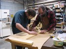 Mike Katz explains table-making to student.