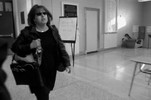 Judi Freeman walking across a lobby at Boston Latin School.