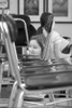 Photograph of the homeroom students gradually entering and lowering their assigned chairs down from their resting spots on top of the tables.