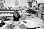 Photograph of Ms. Freeman in her classroom after the meeting. She works on grading and research for her next few days of class.