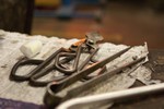 Photograph of tools that a gaffer can use while working his or her glass at the bench. Each tool has a pre-arranged location and orientation.