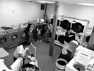 Photograph of a laundromats showing a wide variety of people. But much like oil and water, you can put different people together in a laundromat but they won’t mix.