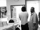 Photograph of a variety of people checking into the laundromat. A couple from India explains that 'potential laundromats have to be a meeting ground for the collaboration of great minds who otherwise would never have met.'