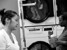 Photograph of a British couple on tour from England who is very excited to be doing laundry for the first time – they explain that at home they 'have people who do that' for them.