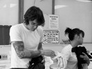 Photograph of a graphic designer and a lady with a dog doing laundry.