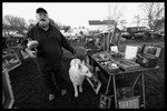 Photograph of Mike Jones, a vendor, showing up at the lot with his big white dog named Leah.