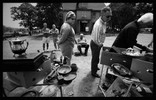 Photo of customers looking over the items for sale.