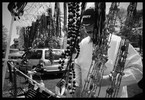 Photograph of a vendor displaying his wares.