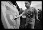 Photograph of a boy pointing at a map.