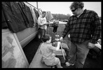 Photograph of a vendor saying good-bye to the boy.