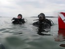 Photograph of other divers, the ones willing to brave the cold, waiting at the surface to descend.