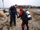 Photograph of a diver showing off his Easter egg prize.