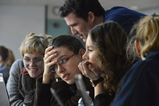 Several girls and women are looking at a computer.